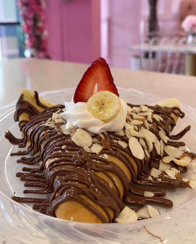 A&J crepe topped with Nutella, sliced bananas, almonds, a strawberry and whipped cream
