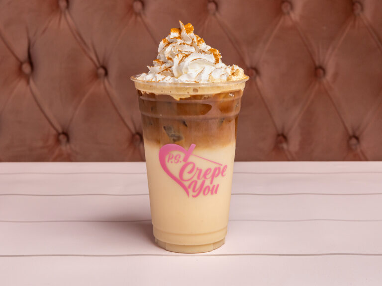Iced horchata latte topped with whipped cream and cinnamon
